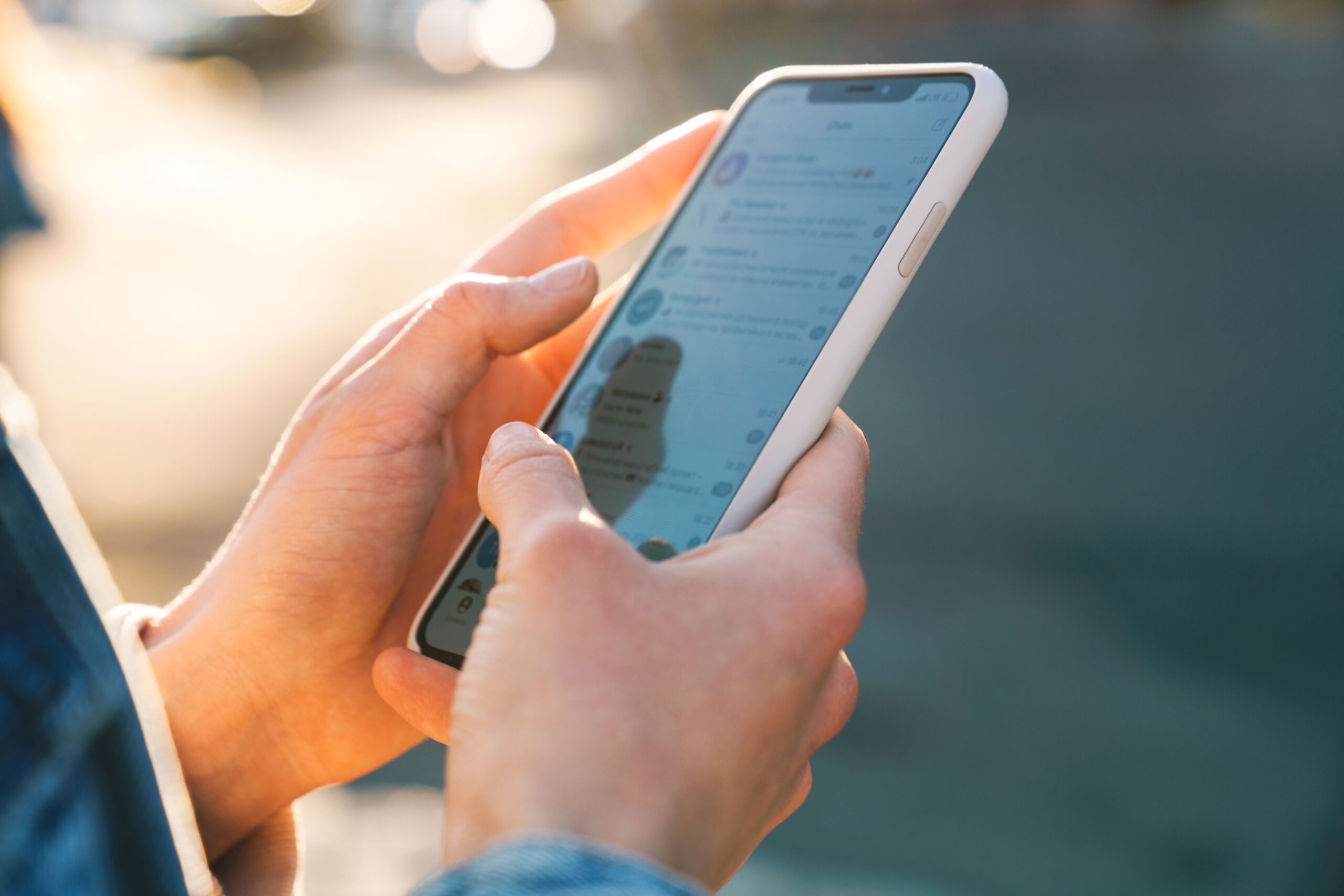 Alt text, Hashtags, image of a woman using social media on her phone with a pink cover.