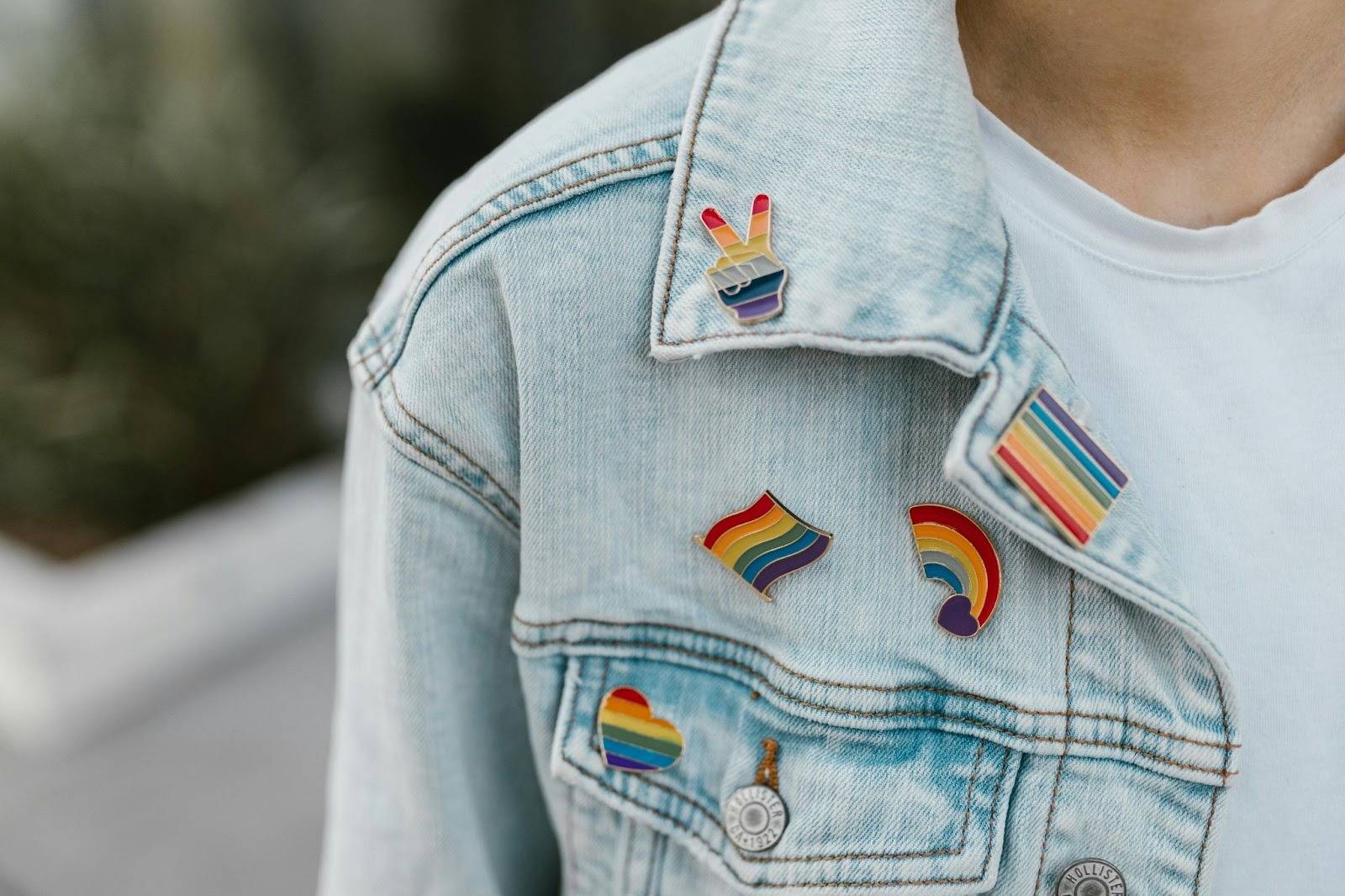 LGBT therapy directories, image of a denim jacket with LGBTQ pride pins attached.