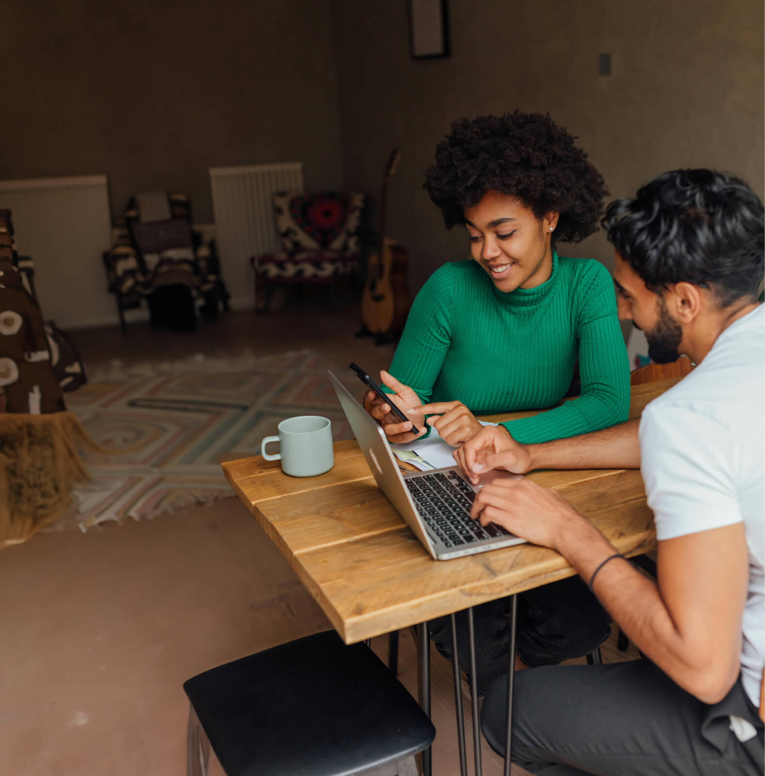email testing , throwaway emails, image of two people sitting at a wood table working together with a laptop and looking at a phone.