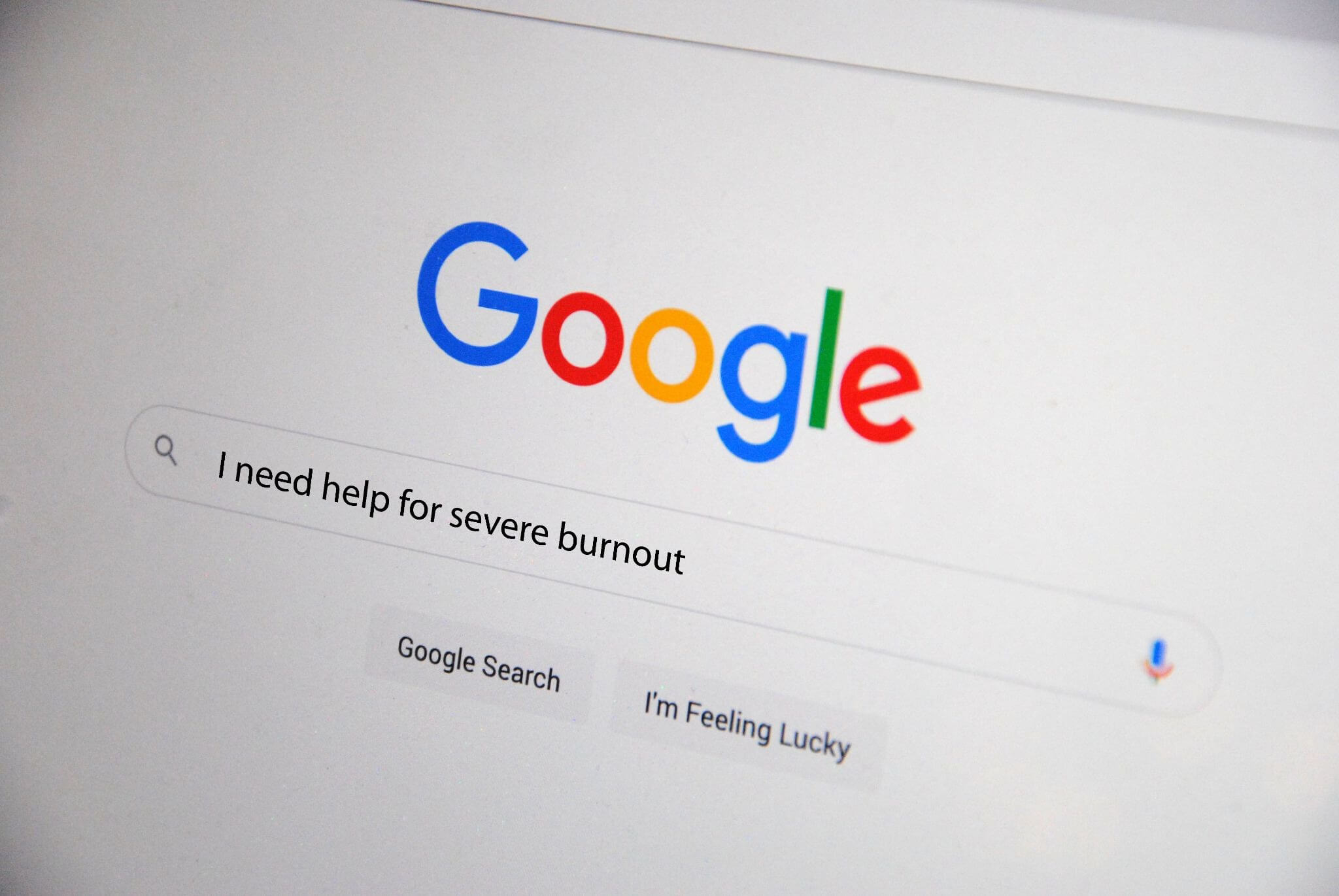 image of a Google homepage with the words “I need help for severe burnout” typed in the search bar.